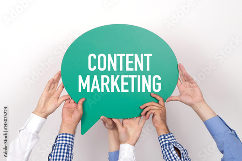 Group of people holding the CONTENT MARKETING written speech bubble