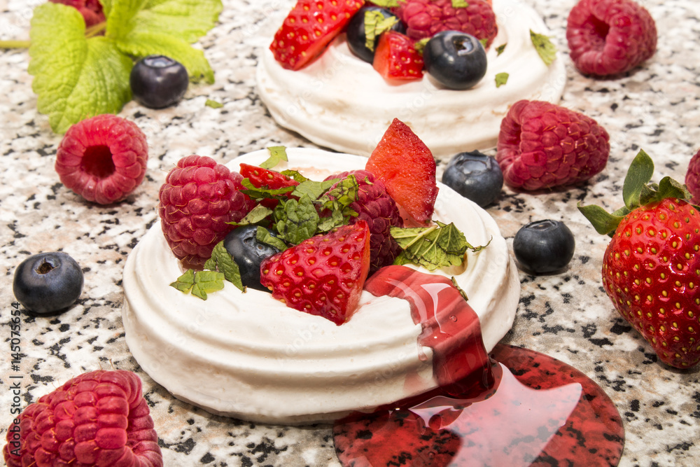 pavlova with fresh sliced, sugared fruit and lemon mint pavlova with fresh sliced, sugared fruit and lemon mint