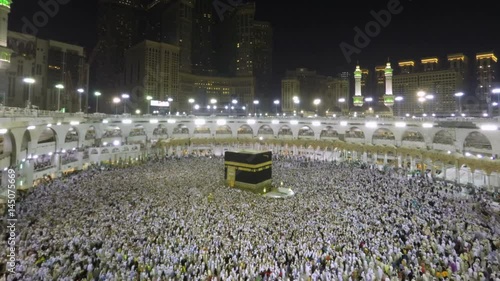 Time lapse video of Muslim pilgrims circling around the holy Kaaba at night during Hajj inside al Masjid al Haram in Mecca, Saudi Arabia. Camera zooms in through the Kaaba. photo