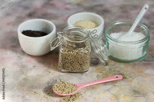 Gomasio- sesame salt. Jar, small bowls with ingredients. 