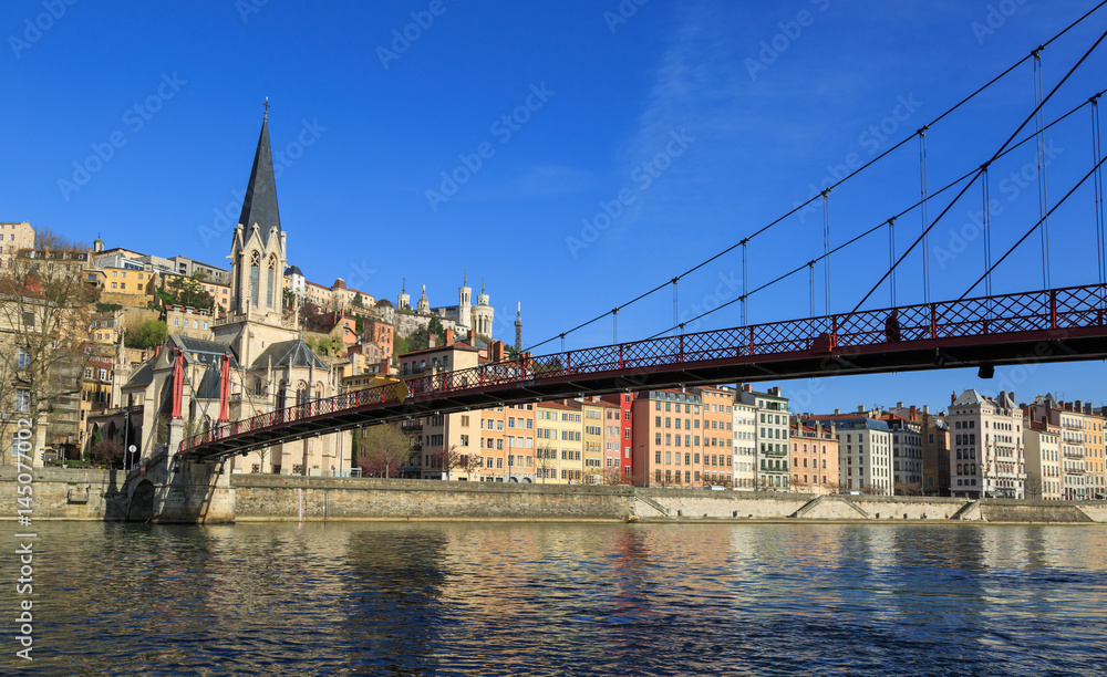Fototapeta premium Church of Saint Georges and footbridge (Passerelle) over the Saone river in Lyon, France.