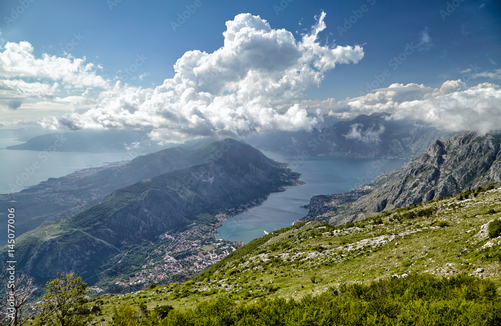 Fototapeta premium Top view of Kotor, Montenegro, Europe. Boka Kotor bay Boka Kotorska is one of the most beautiful places on Adriatic Sea, it boasts the preserved Venetian fortress, old towns and scenic mountains.