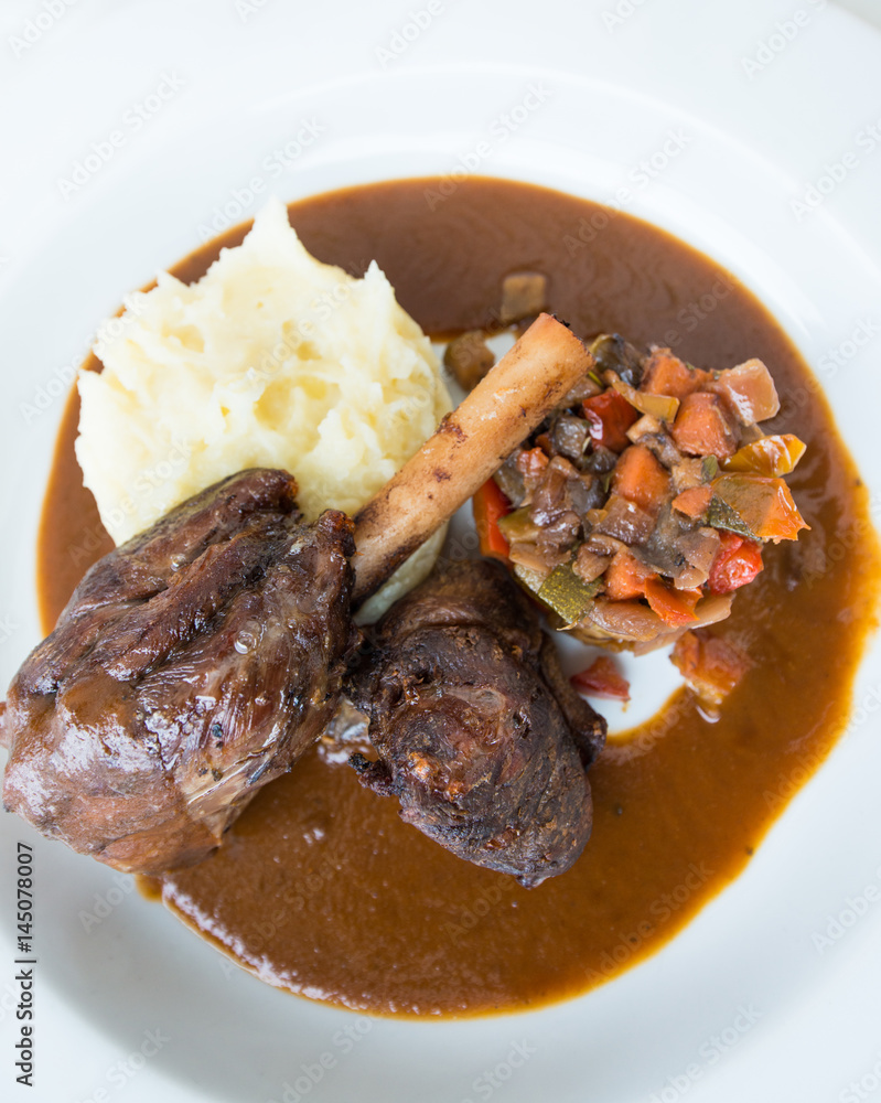 Roast lamb shank with Vegetables and potato paste