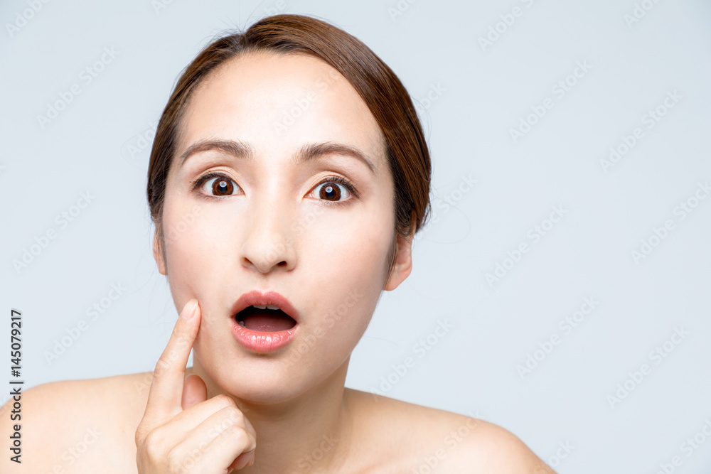 middle aged woman who checks her skin. acne treatment. middle aged woman who checks her skin. acne treatment.