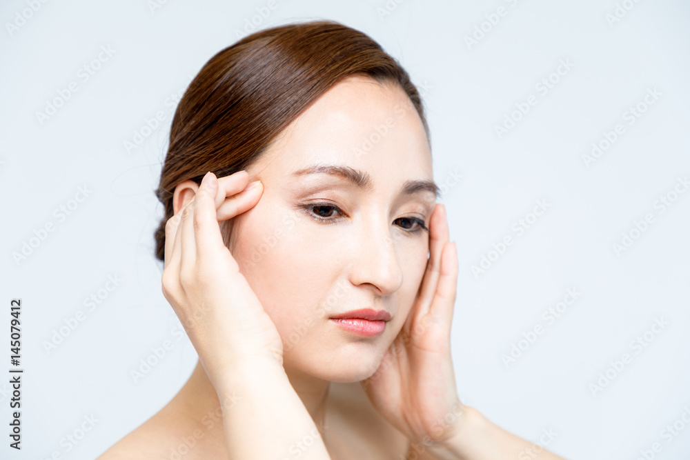 beautiful woman massaging her face. lymphatic massage. beautiful woman massaging her face. lymphatic massage.