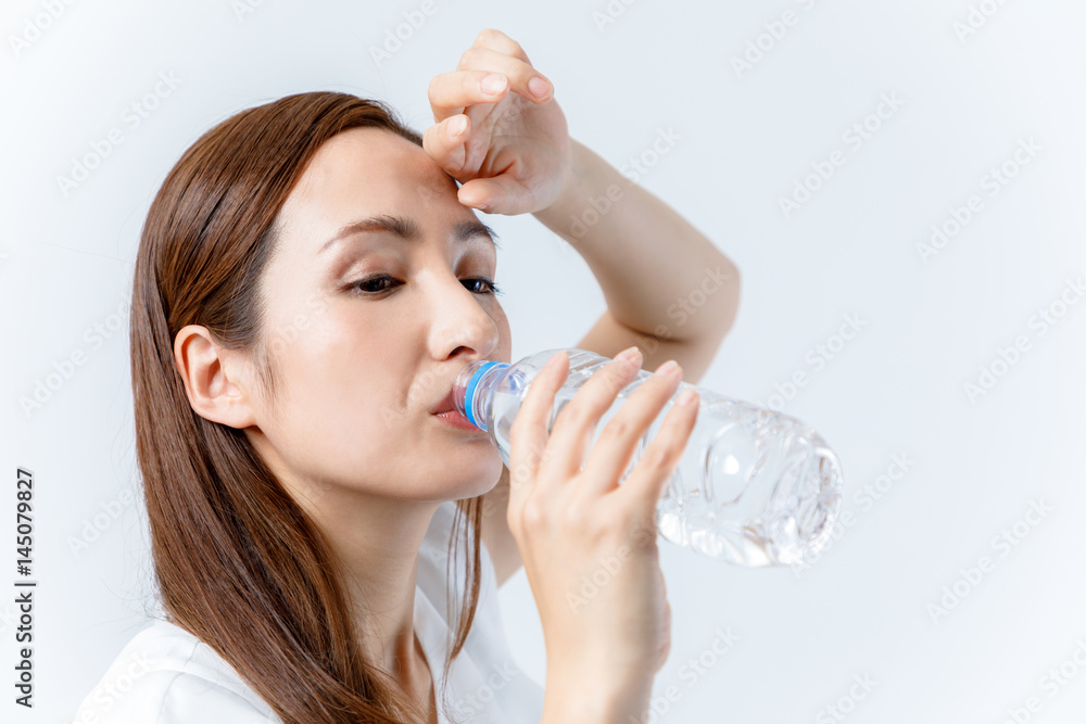 hydration concept. a young woman drinking a bottle of water. hydration concept. a young woman drinking a bottle of water.
