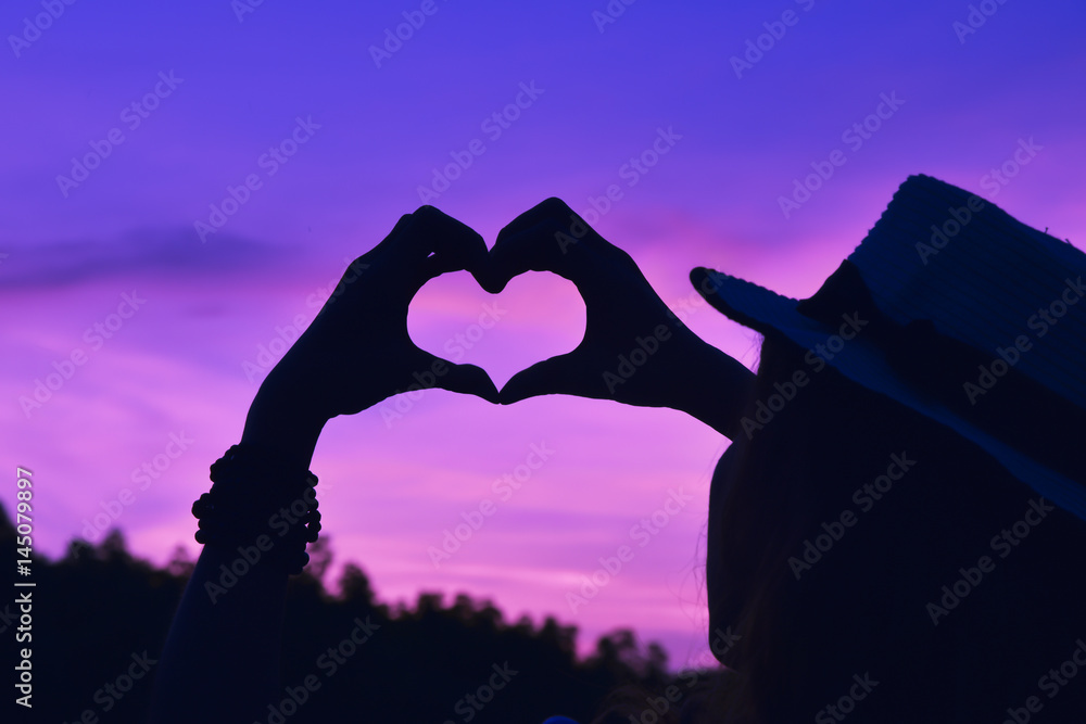 Silhouette hand in the heart shape at the sky sunset   concept Stock Photo | Adobe Stock
