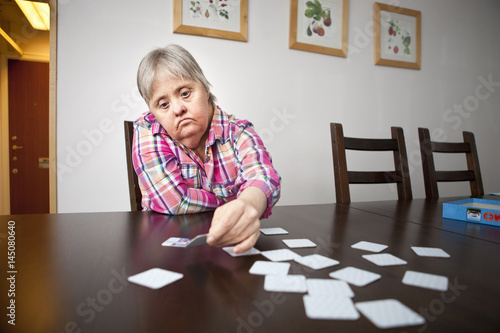 Senior woman playing memory game at home photo