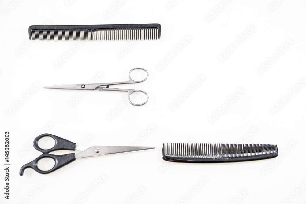 Hair cutting shears and comb isolated on white Hair cutting shears and comb isolated on white