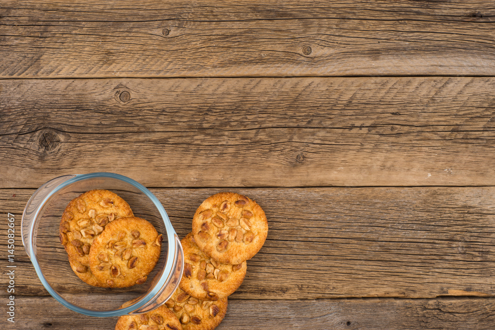 Peanut cookies in a glass bowl on old wooden table. Peanut cookies in a glass bowl on old wooden table.
