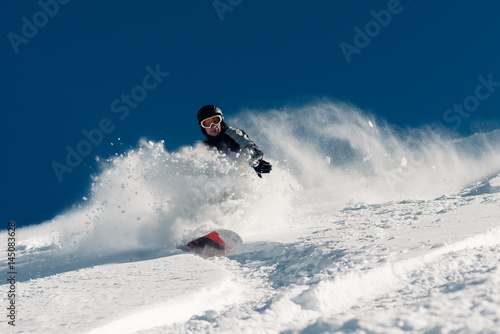 snowboarder is riding from snow hill