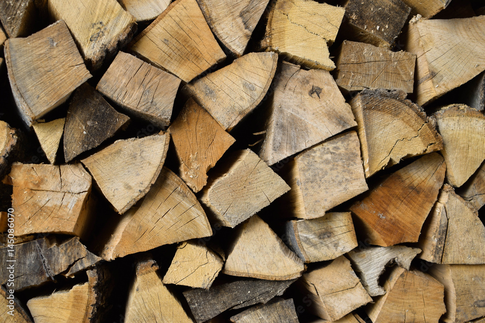 Firewood for fire expansionfirewood. Chopped wood. Wooden background Firewood for fire expansionfirewood. Chopped wood. Wooden background