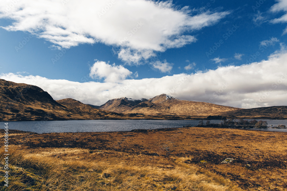 Glencoe landscape in Scotland on sunny day with blue sky. Scottish Highlands.