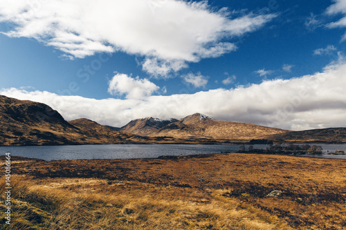 Glencoe landscape in Scotland on sunny day with blue sky. Scottish Highlands.