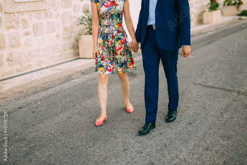 Female and male feet on the pavement. Wedding in Montenegro © Nadtochiy