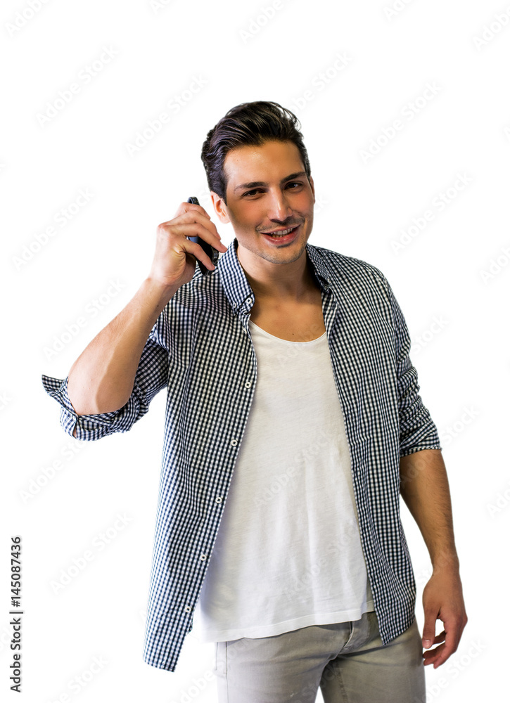 Handsome young man talking on cell phone, smiling Handsome young man talking on cell phone, smiling
