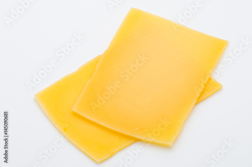 Cheese slices on white background cutout.