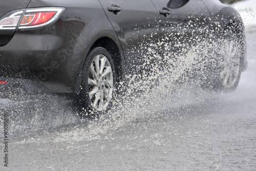 Splashing water from under the car wheels