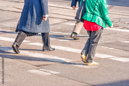 women feet, crossing an urban street