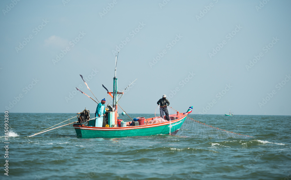 Phang-Nga, Thailand - October 31, 2015 Fishermen on boat fishing at sea in Phang-Nga, Thailand Phang-Nga, Thailand - October 31, 2015 Fishermen on boat fishing at sea in Phang-Nga, Thailand