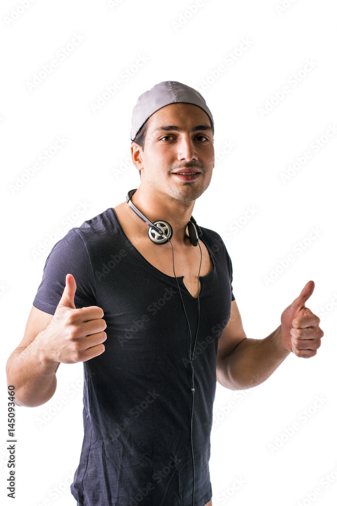 Naklejka premium Good looking guy with headphones, smiling, thumbs up