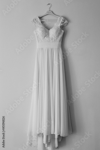 The bride's dress on a hanger in the room in Montenegro