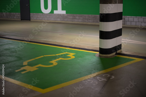 Electric car parking place in public garage