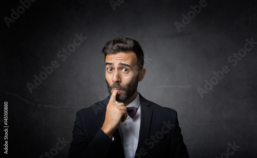 elegant man with finger in mouth