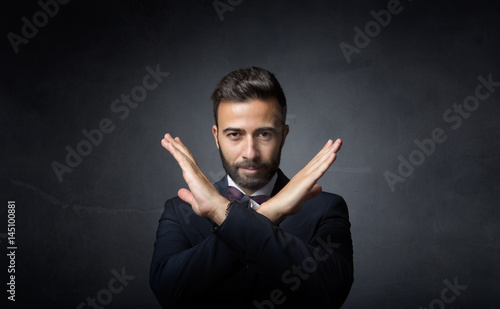 elegant man gesturing x with hands