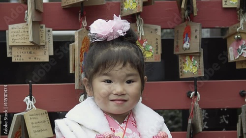 A three year old girl with her Mother dressed up in a Kimono to celebrate the Shichi-Go-San Festival photo