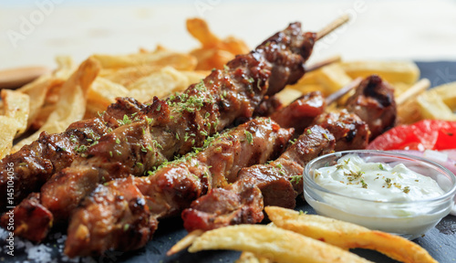 Foto Grilled meat skewers and side dish