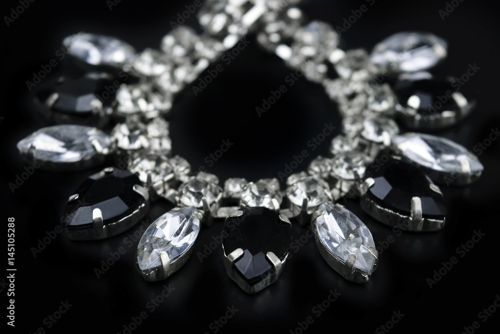black and white jewelry with dark background. low key picture style of commercial product. black and white jewelry with dark background. low key picture style of commercial product.