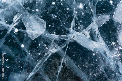 Abstract background of ice and cracks on the surface of frozen Lake Baikal photo