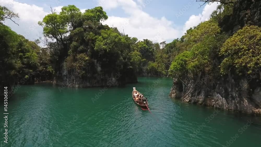 Traditional Thai Long Tail Boat Sailing with Tourists at Cheow Lan Lake. Surat Thani Province, Thailand. Aerial HD. Traditional Thai Long Tail Boat Sailing with Tourists at Cheow Lan Lake. Surat Thani Province, Thailand. Aerial HD.