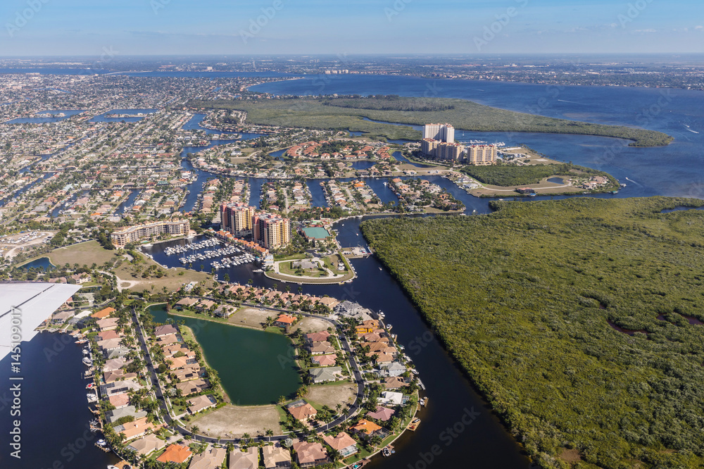 Fototapeta premium Aerial view of city and gulf Cape Coral, Florida. The Westin Cape Coral Resort at Marina Village
