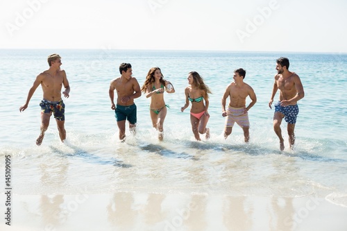 Friends running on shore