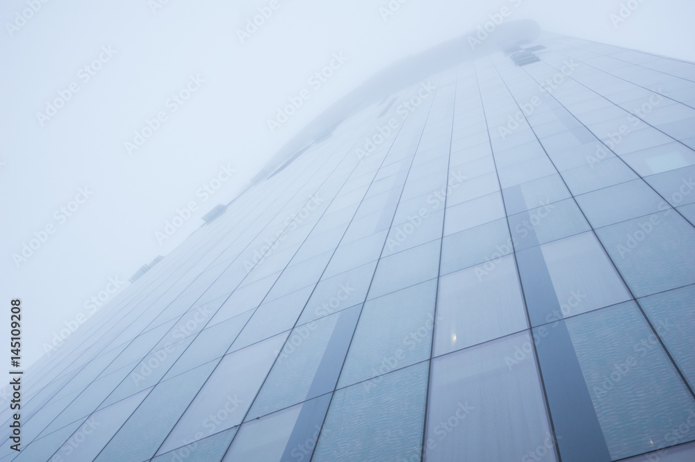 Tall skyscraper disappears in the fog Tall skyscraper disappears in the fog