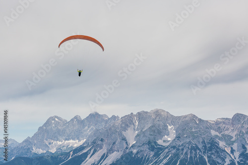 paraglider in front of mountain chain Dachsteinmassiv