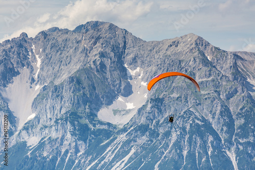 paraglider in front of mountain chain Dachsteinmassiv photo