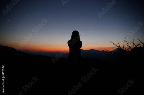 sunset silhouette, young lady in hill