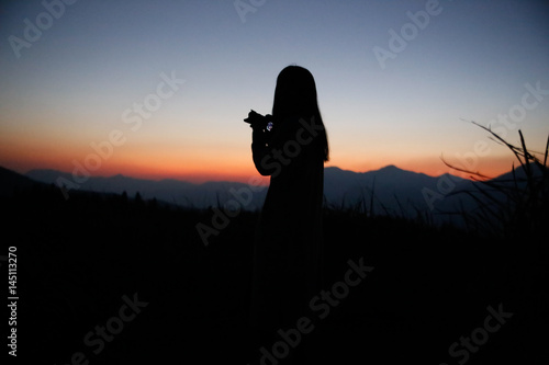 sunset silhouette  young lady in hill