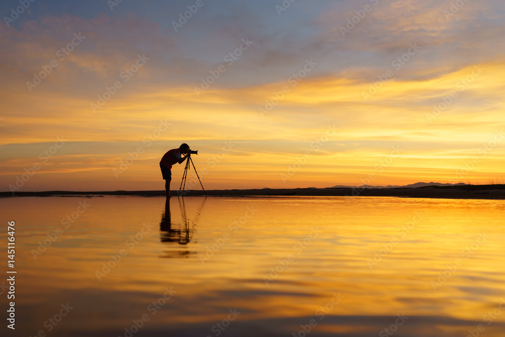 Silhouette Tourist take photo beautiful seascape at sunset in Thailand.
