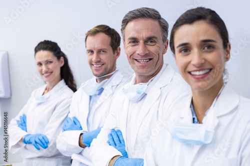 Smiling dentists standing with arms crossed