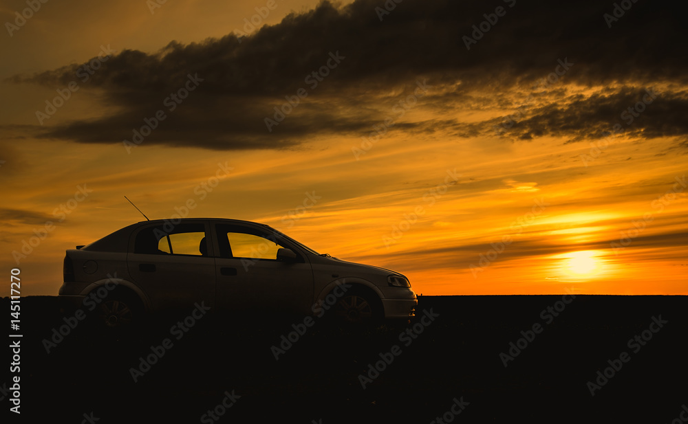 Car silhouette in sunset