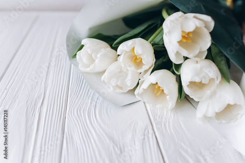 Mother s Day . white tulips on white wooden background