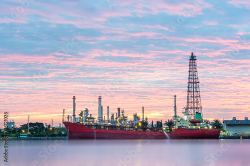 Big red ship infront of Oil refinery factory at dawn, Oil refinery - Bangkok, Thailand