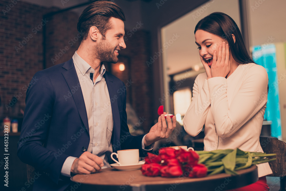 Making proposal in a cafe with ring and flowers Making proposal in a cafe with ring and flowers