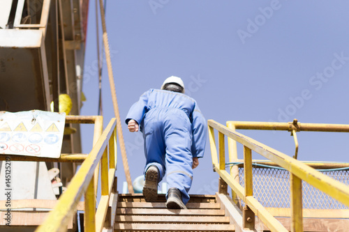 An engineer climbing the staircase to the platform