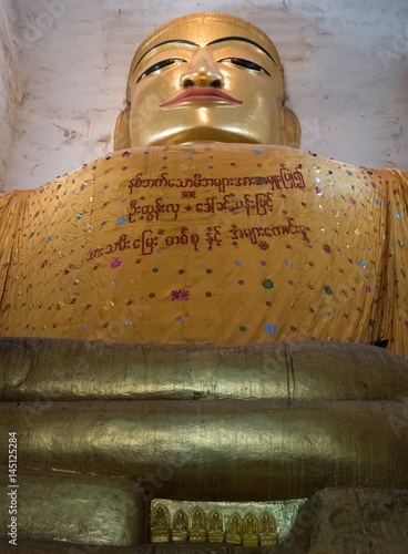 Buddha statue in Manuha Temple, Bagan, Myanmar photo