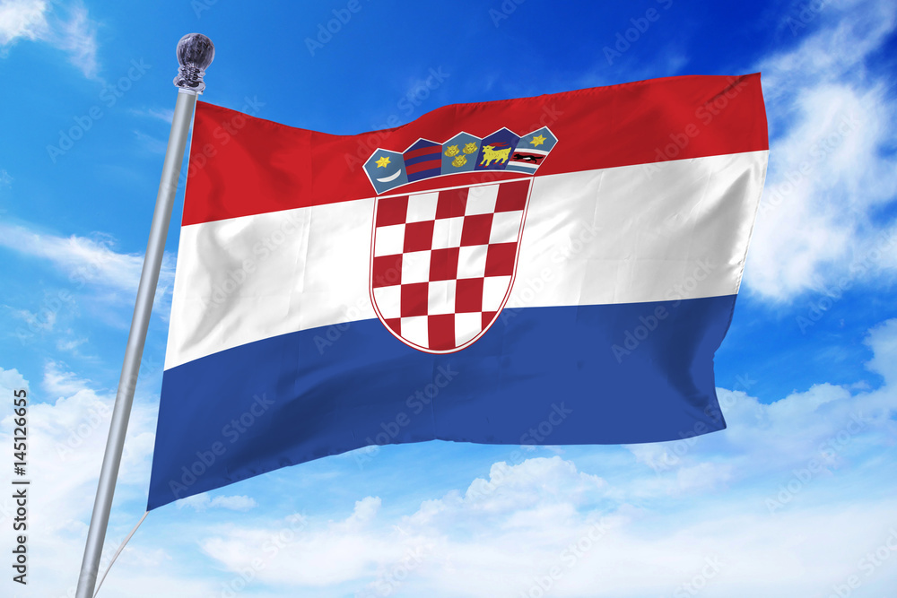 Naklejka premium Flag of Croatia developing against a clear blue sky